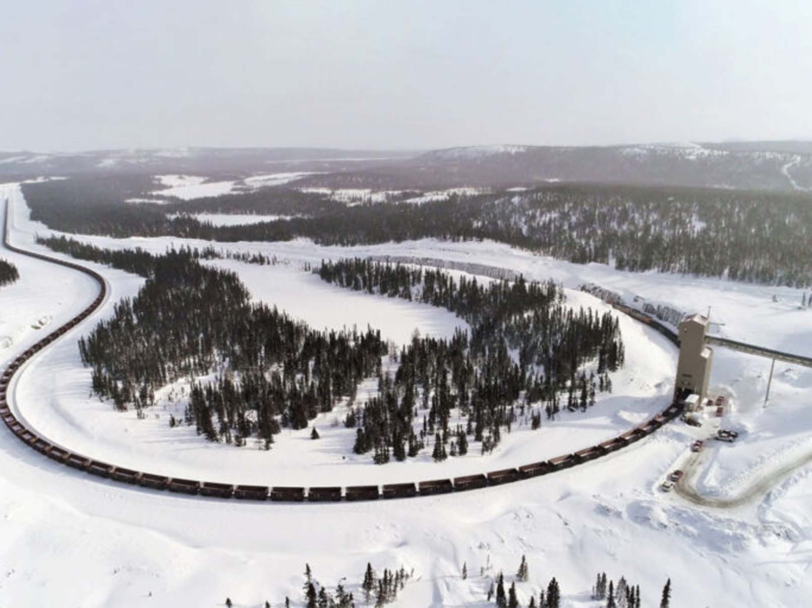 Aerial shot of a train in a snowy area