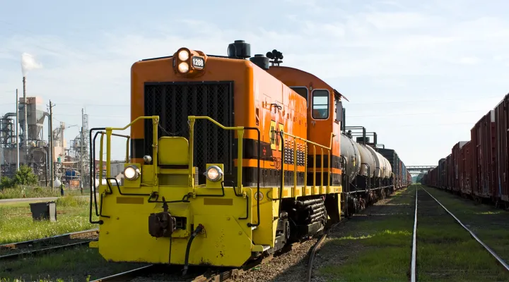Caboose of train with tank cars in front of it