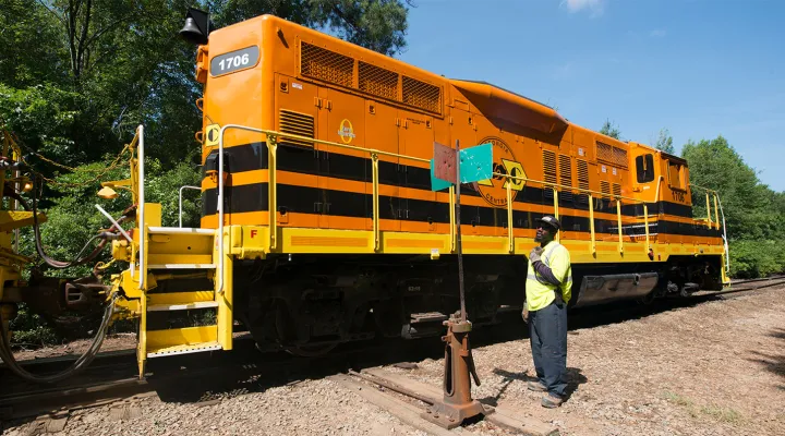 Train caboose with a G&W employee next to it